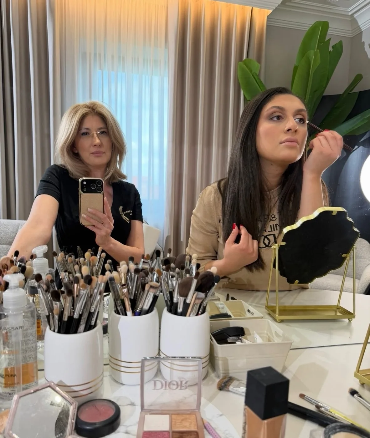 Curs de automachiaj: cursanta se machiază în oglindă, alături de Oana Arvinte